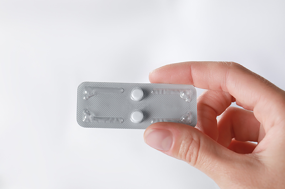 Woman holding a blister pack of abortion pills