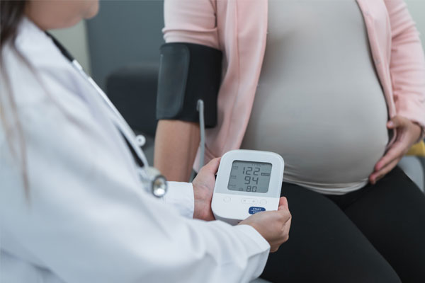 A doctor running tests on her pregnant patient