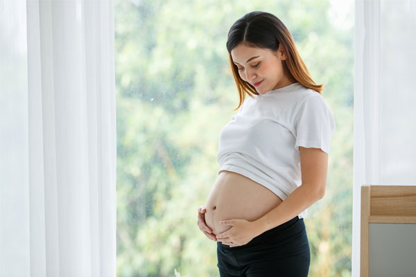 A pregnant woman holding her belly
